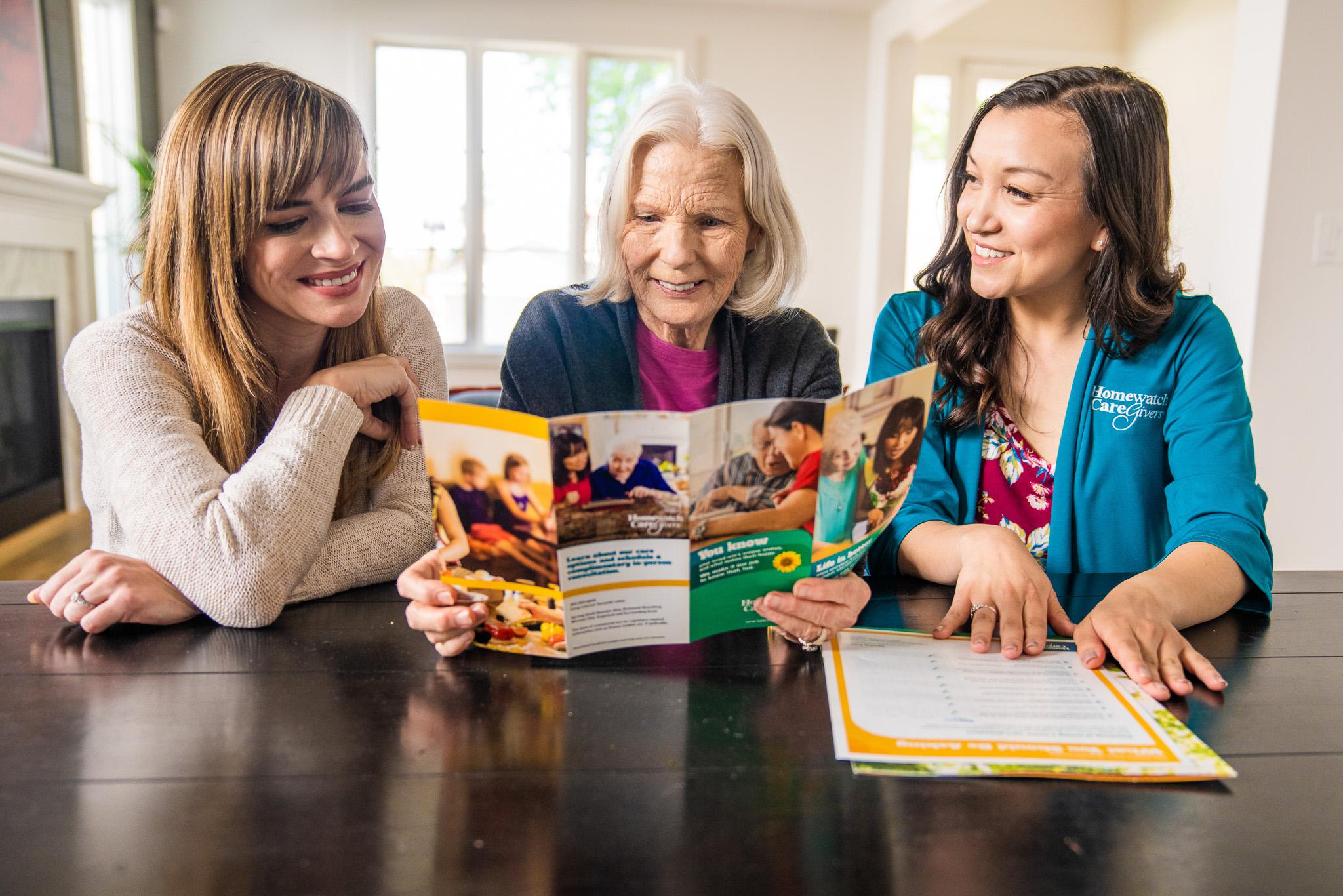 An elderly woman looking at a brochure