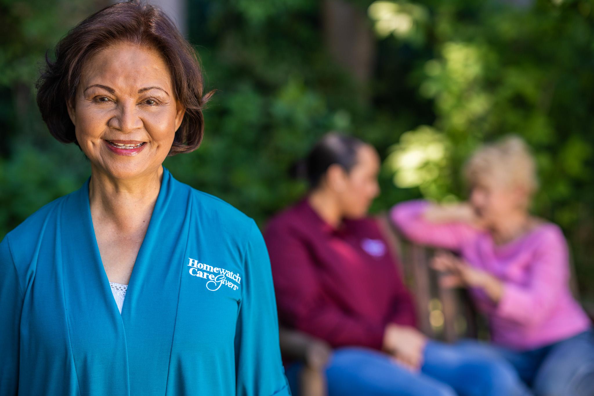 A caregiver sitting outside with a patient