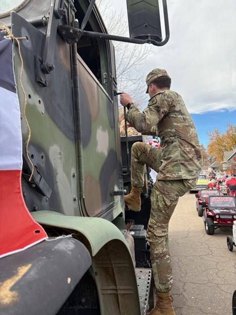 A person climbing up the side of a truck
