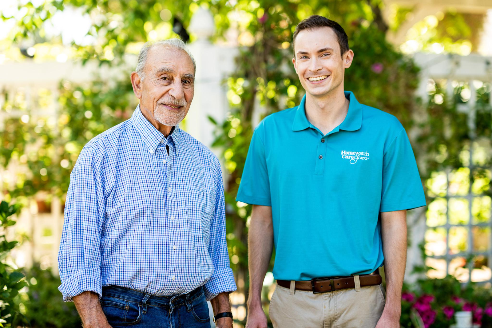 An aide and client smiling