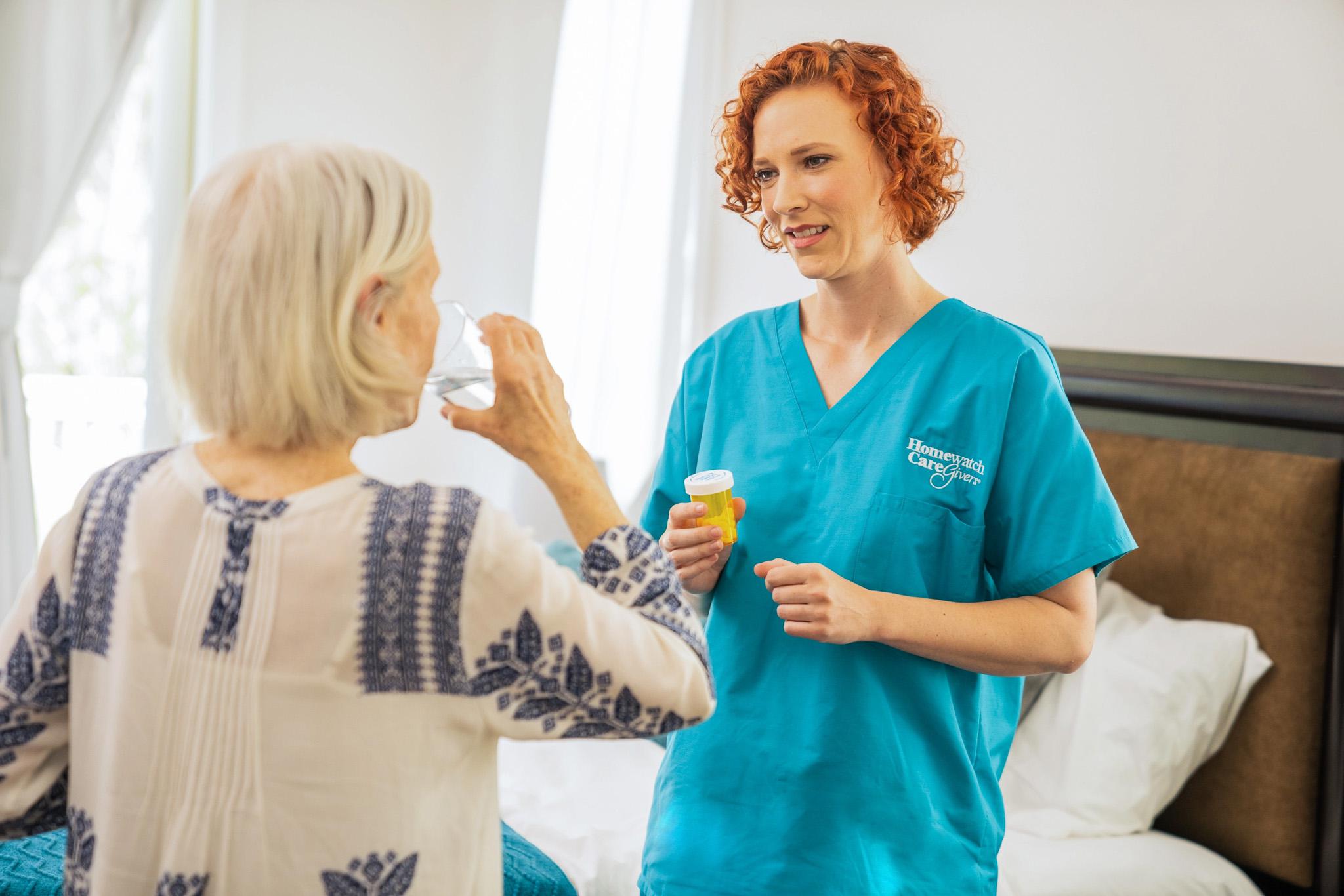 A caregiver helping a patient with their medication
