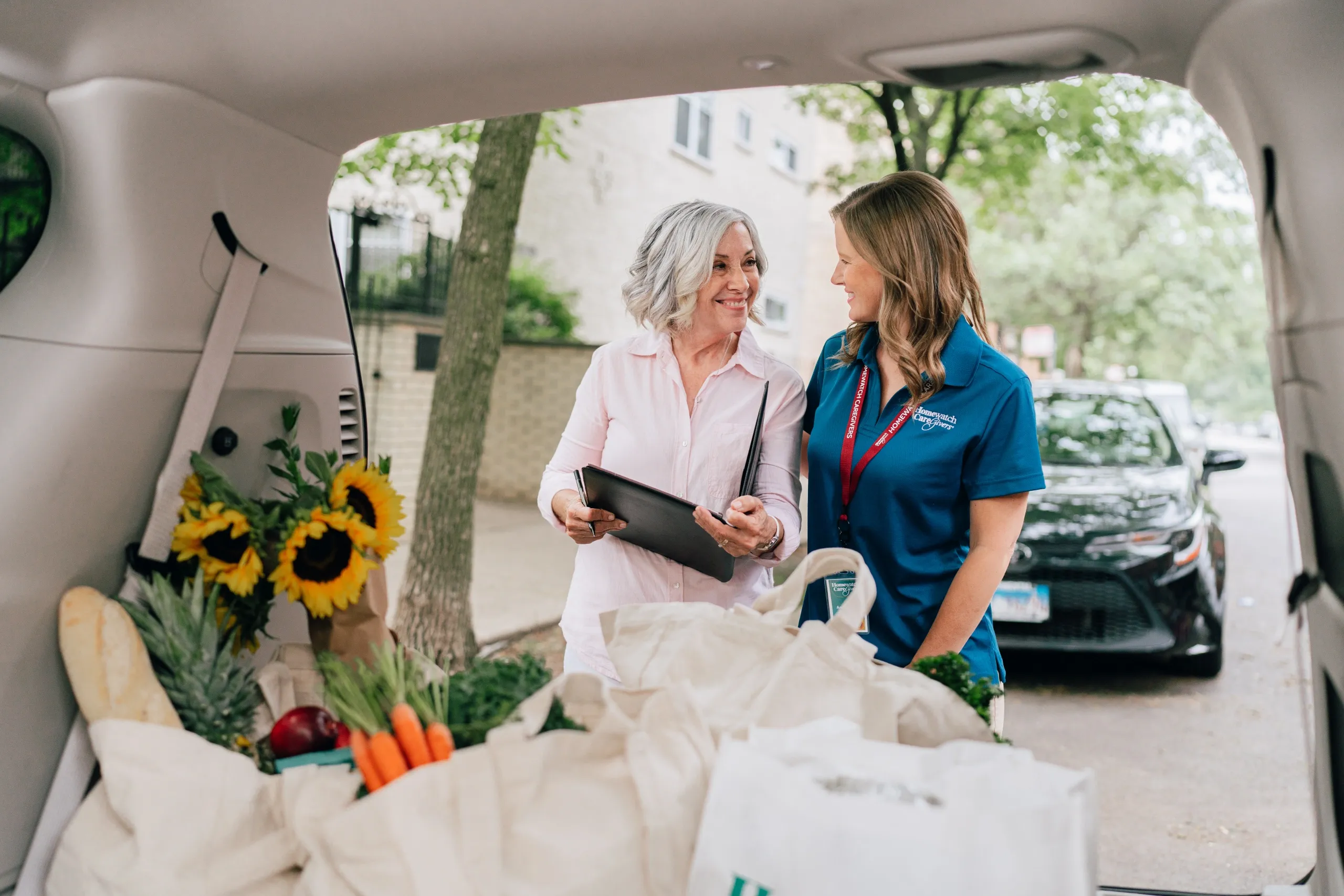 A caregiver helping a patient transport grocery bags
