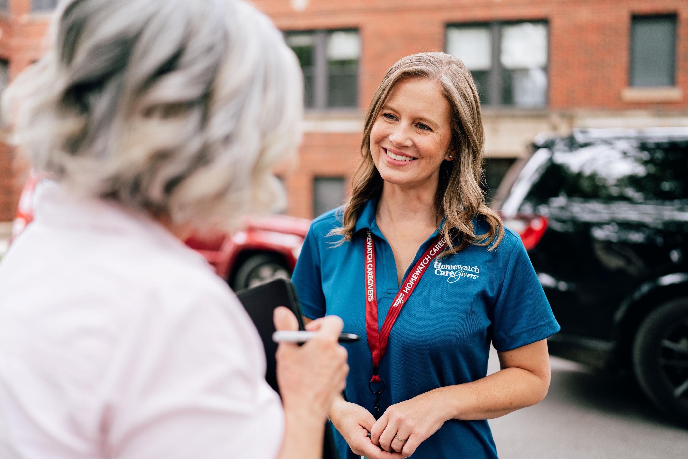 Older woman facing smiling caregiver