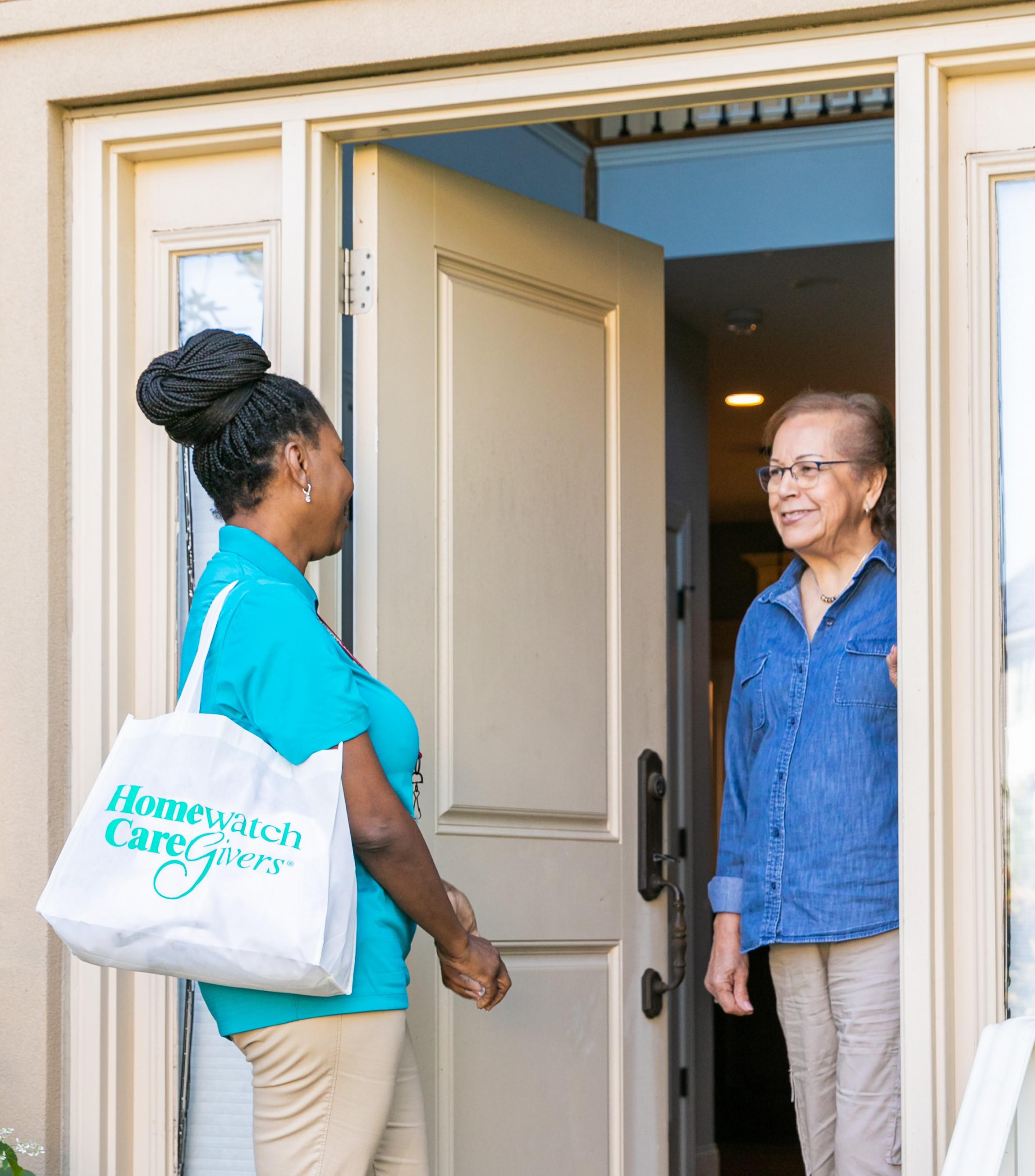 caregiver standing in door talking to patient