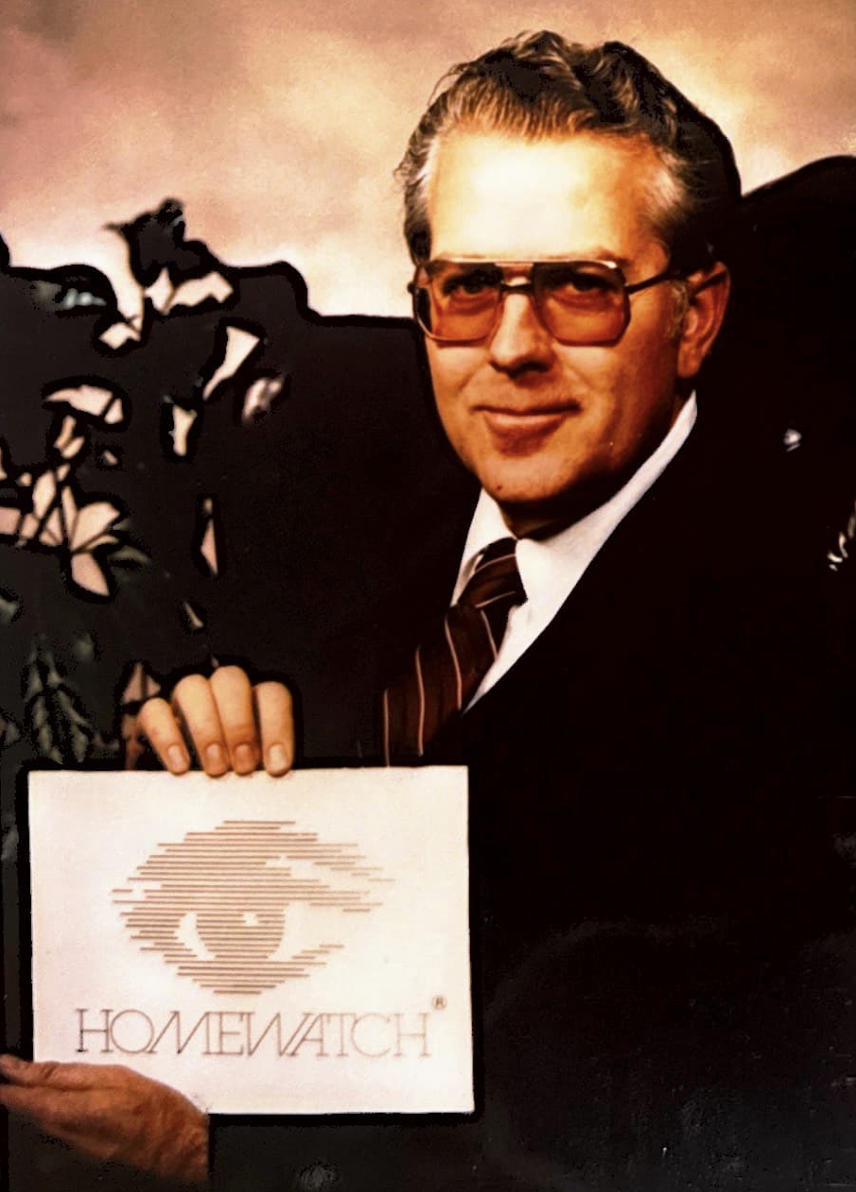 Man holding image of eye with Homewatch CareGivers name below