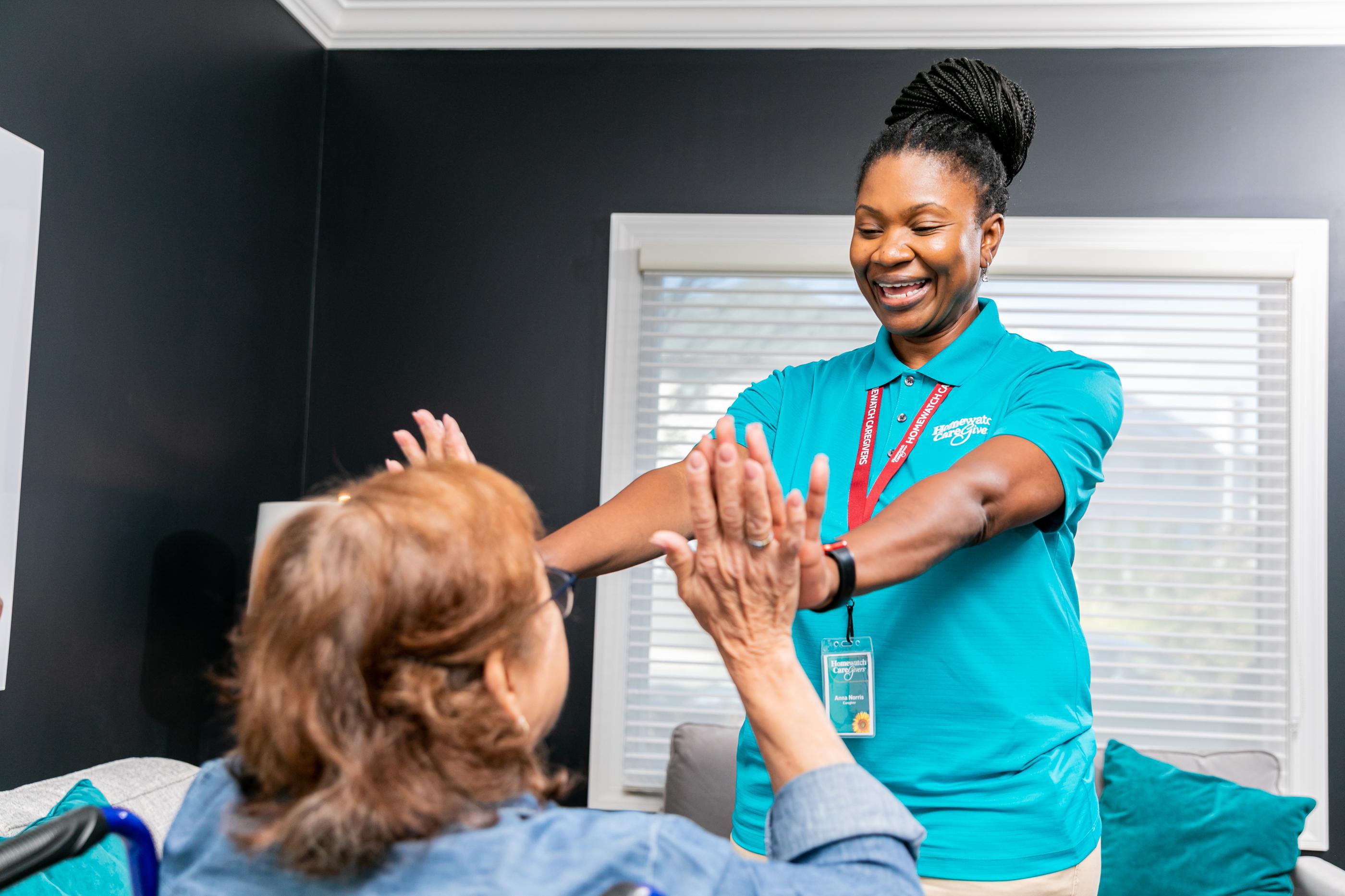 caregiver high fiving woman