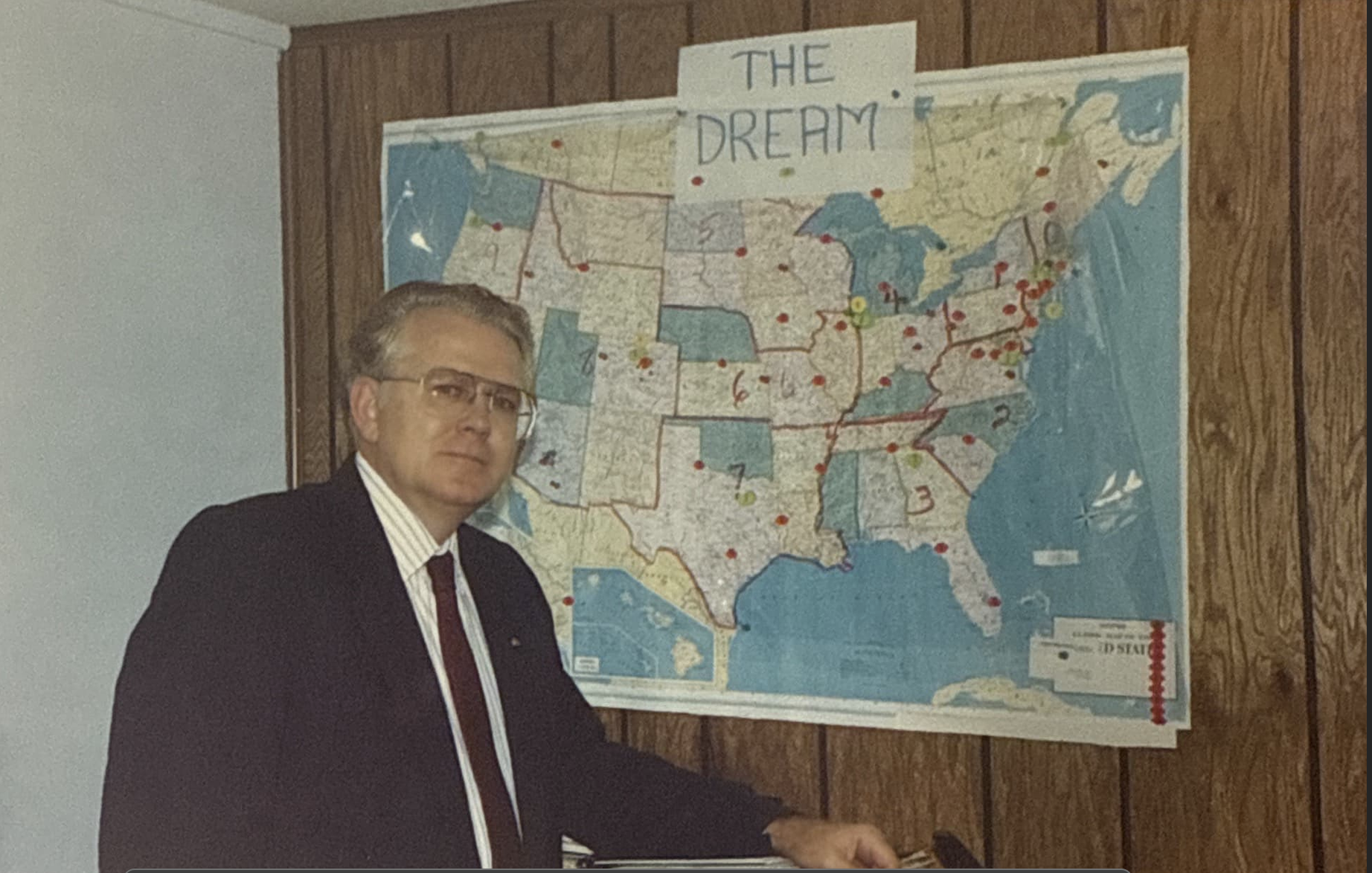 older image of owner in front of US map