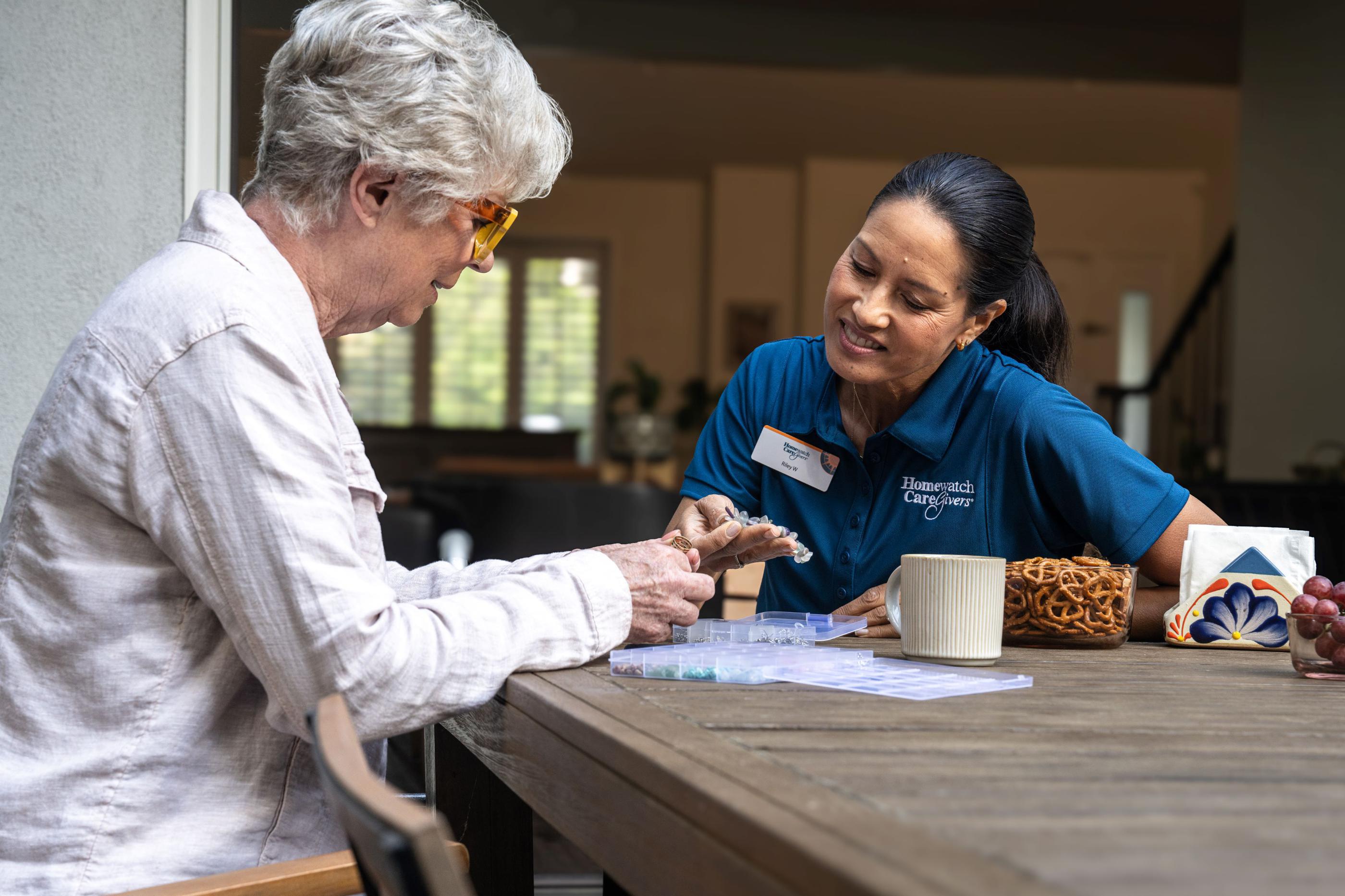 Woman at table with female caregiver