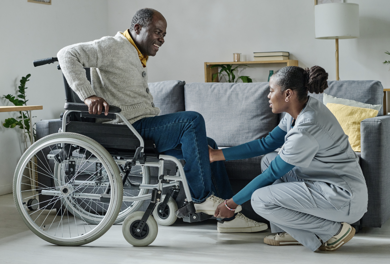 A caregiver helping a patient in a wheelchair
