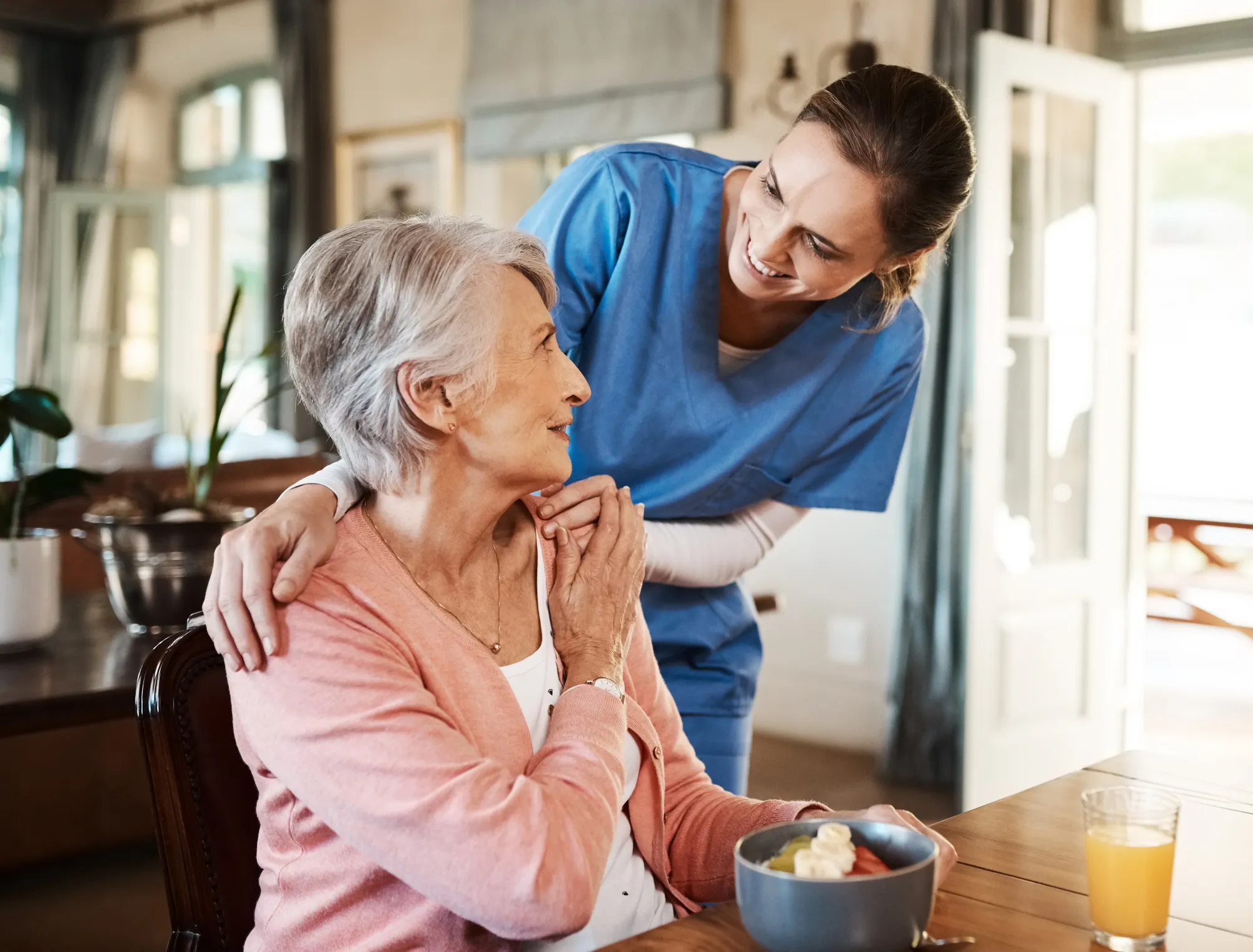 Woman at table with female caregiver
