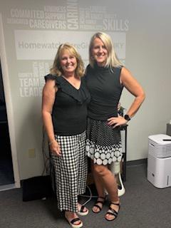 Two women smiling next to each other