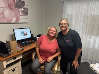 Two women smiling next to each other