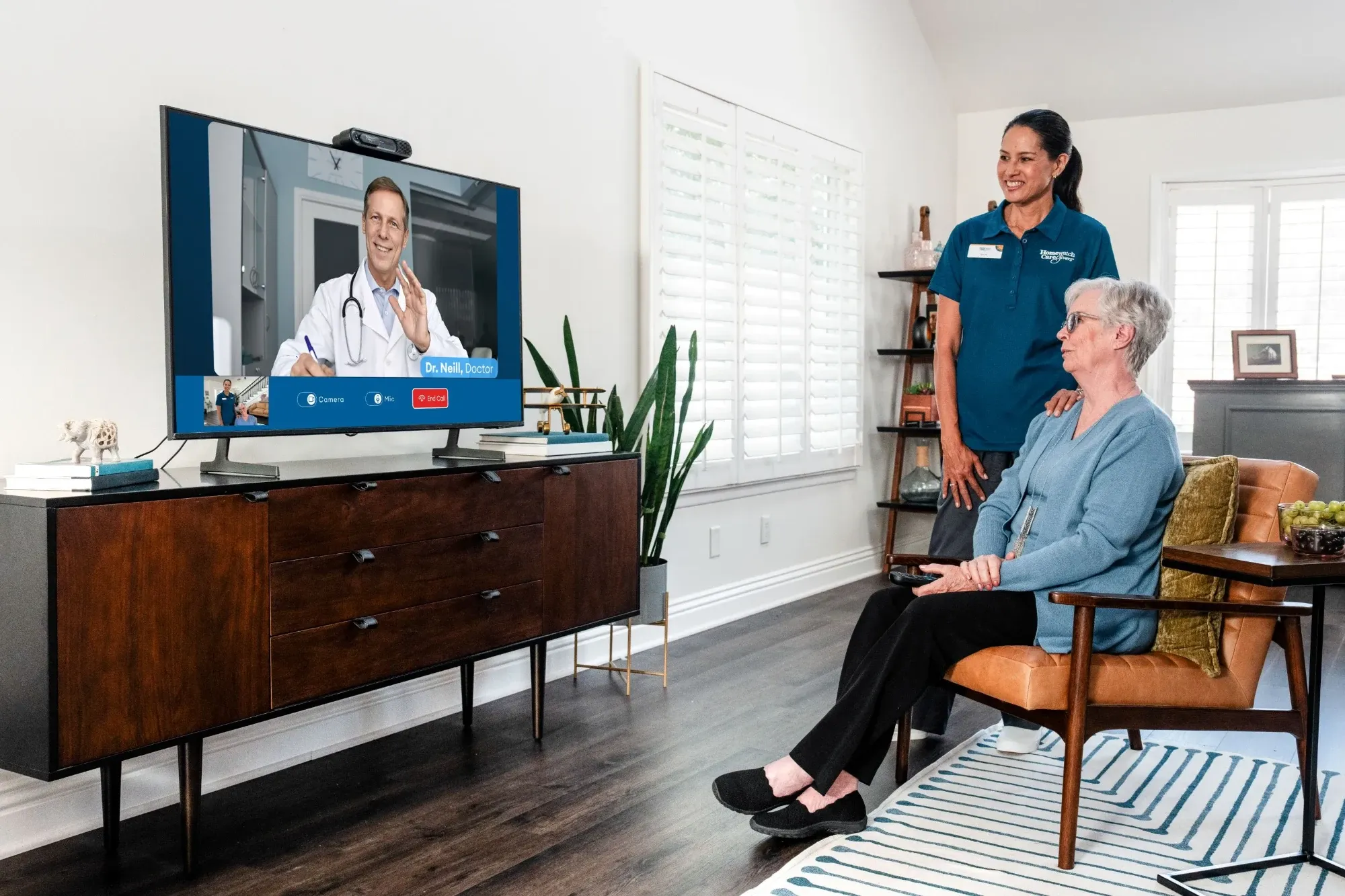 Woman and caregiver watching tv