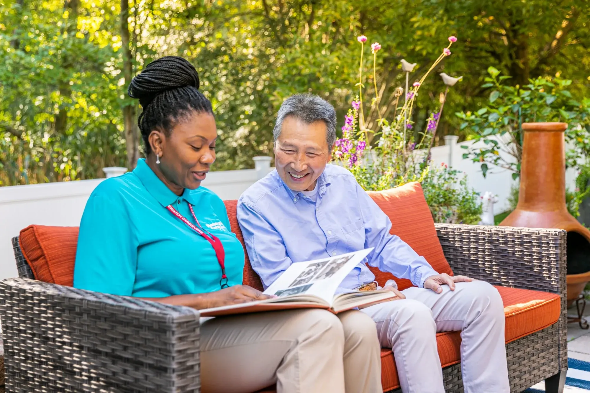 Man and cargiver sitting at bench