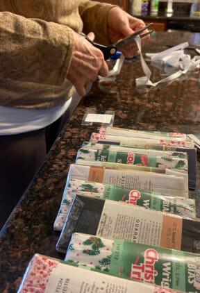 Caregiver helps senior make masks for frontliners