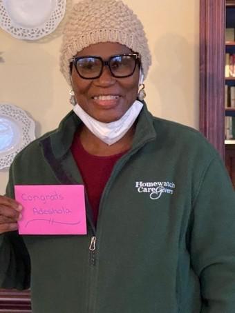 Adeshola Oshinaike smiling with her card