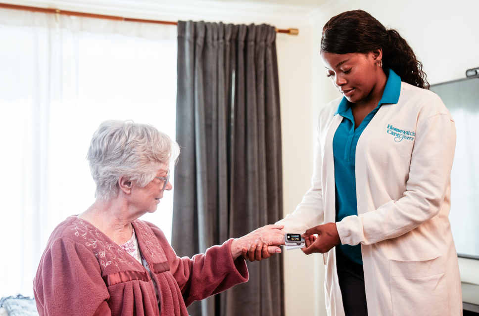 caregiver taking data from finger device