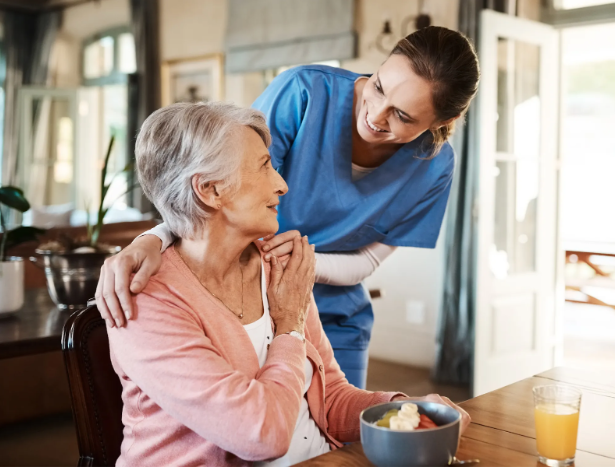 nurse smiling and holding woman's shoulders