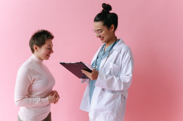 doctor reading off clipboard to woman