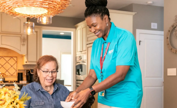 nurse giving woman bowl