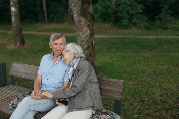 woman resting head on mans shoulder