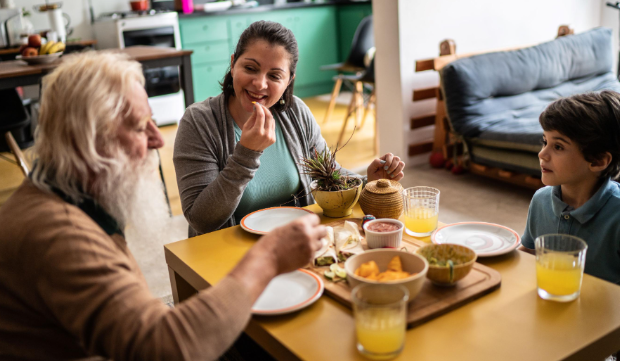 three people sitting at breakfast table