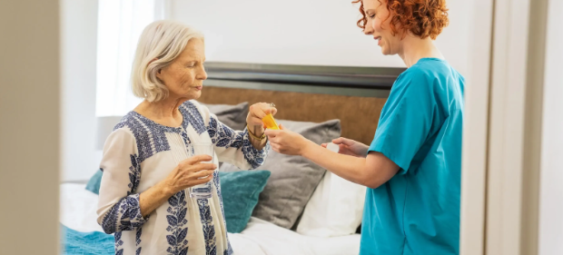 nurse handing pills over to woman