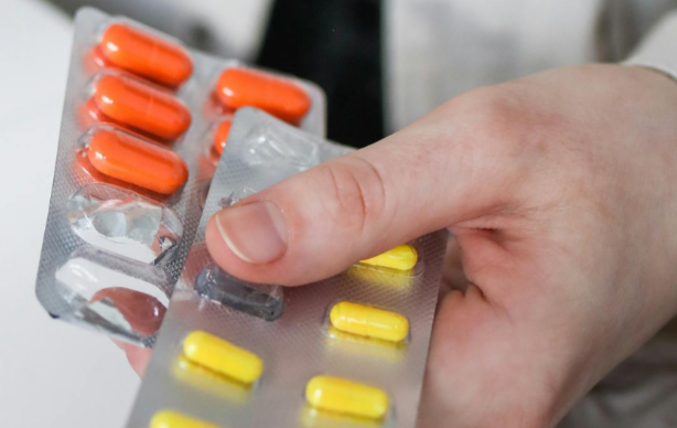 open pack of orange and yellow pills