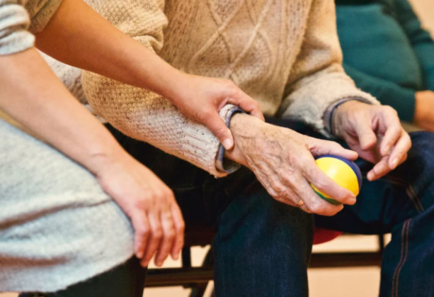 woman holding person's writs with ball in hand