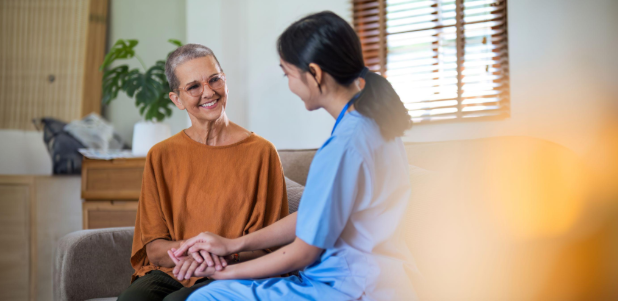 woman and caregiver holding hands
