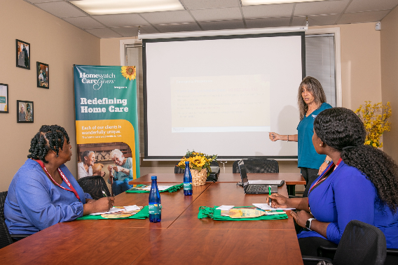 A person standing in front of a white board

Description automatically generated