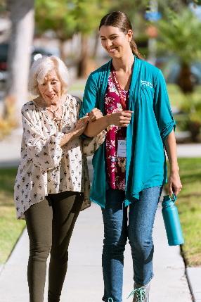 A person holding an older person's hand