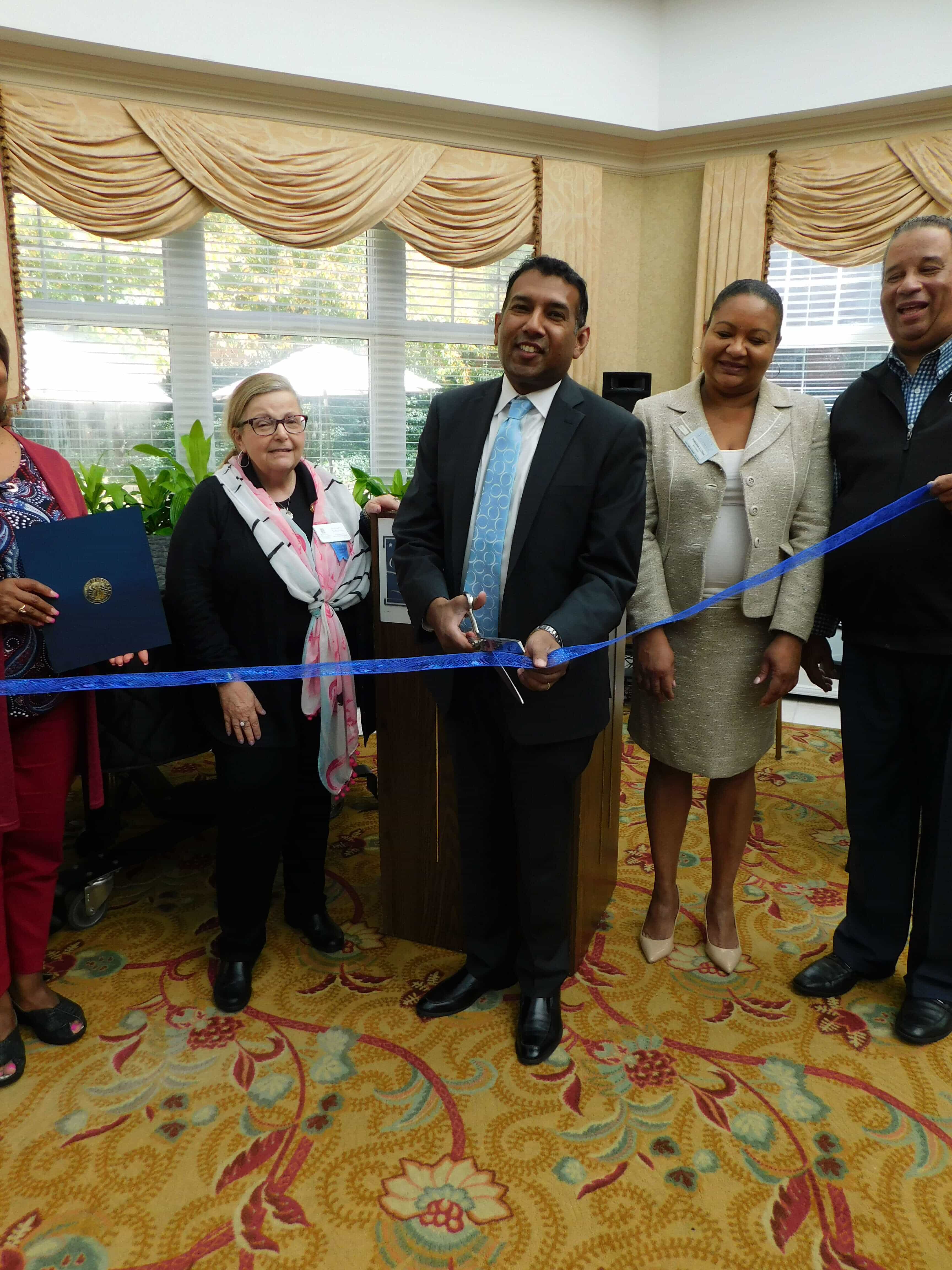 A man cutting the ribbon for the ceremony 
