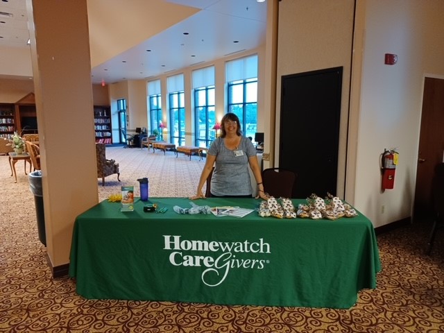 hwcg employee standing at check in table