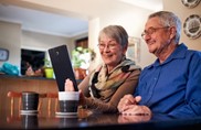 a couple looking at an ipad