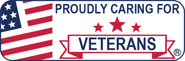 A text badge with a United States Flag. The text reads "PROUDLY CARING FOR VETERANS" 